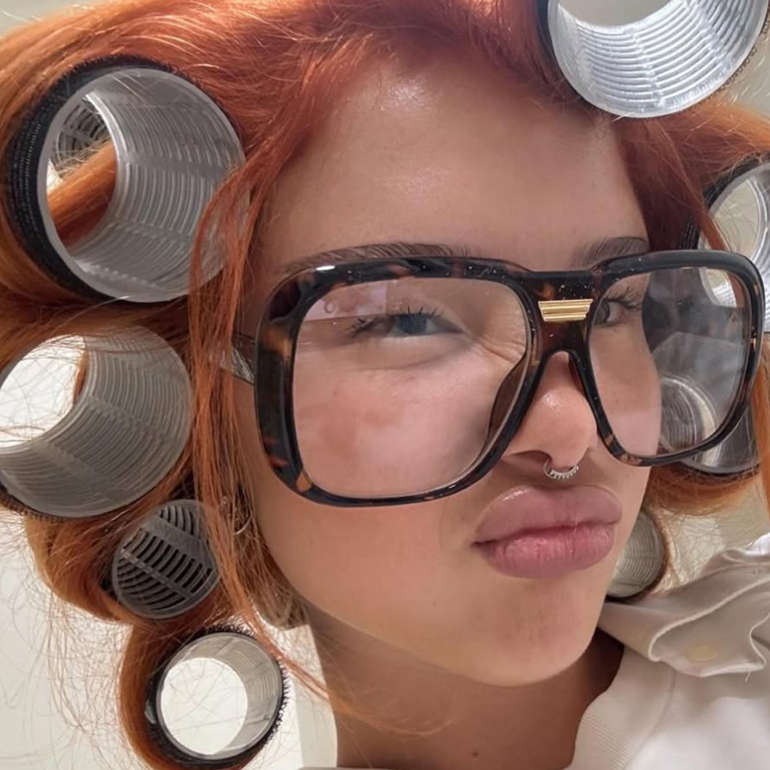 Woman wearing oversized chunky clear glasses with a tortoise frame by Giant Vintage. style: Hipster