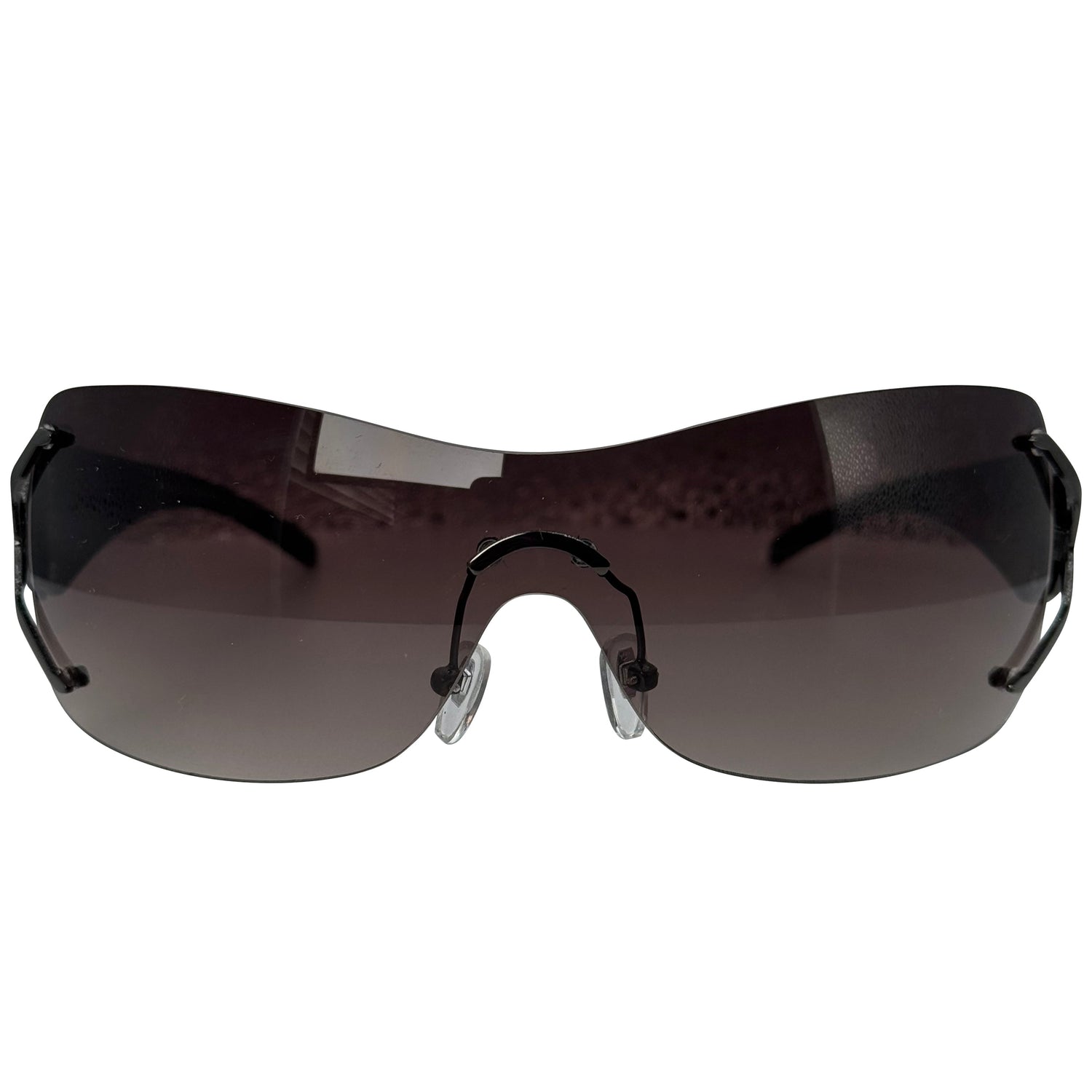 Rimless shield-style sunglasses with a dark brown tinted lens and black frame, shown against a plain white background.