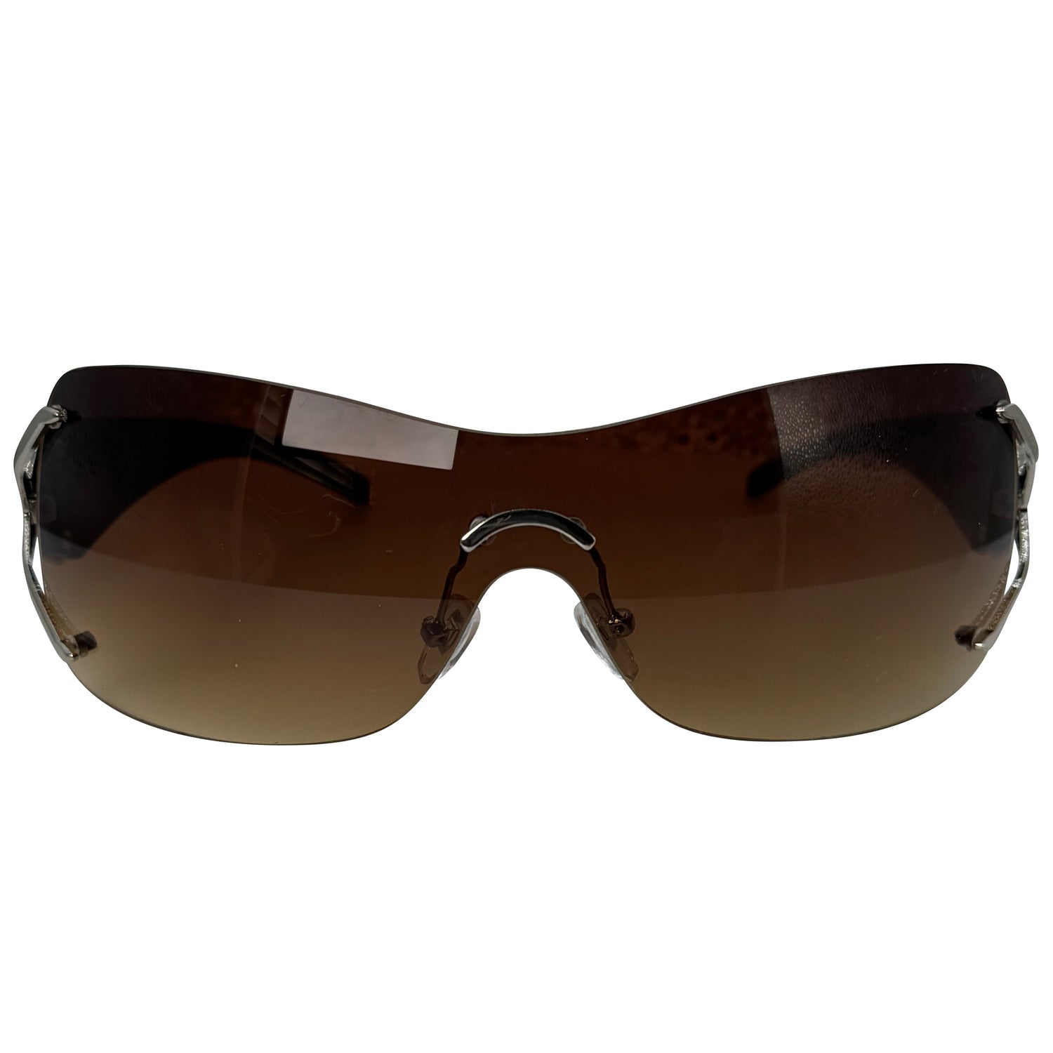 Rimless wraparound sunglasses with dark brown gradient lenses and a black metal frame, shown against a plain white background.