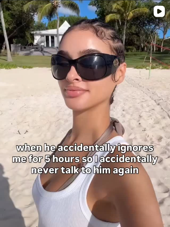 Person wearing sunglasses and a white tank top on a sandy background with text overlay.