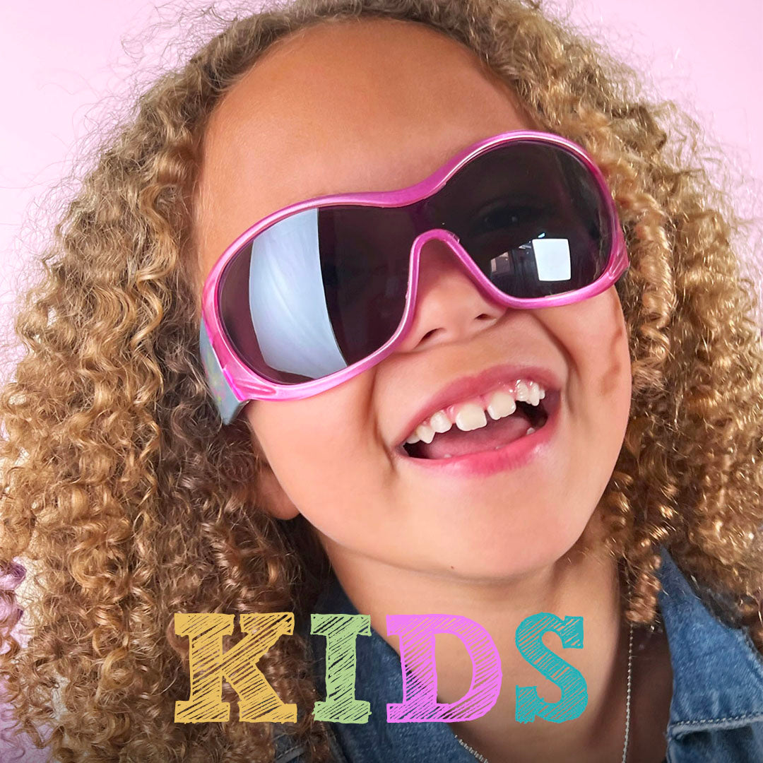 kid in oversized shield sunglasses pink