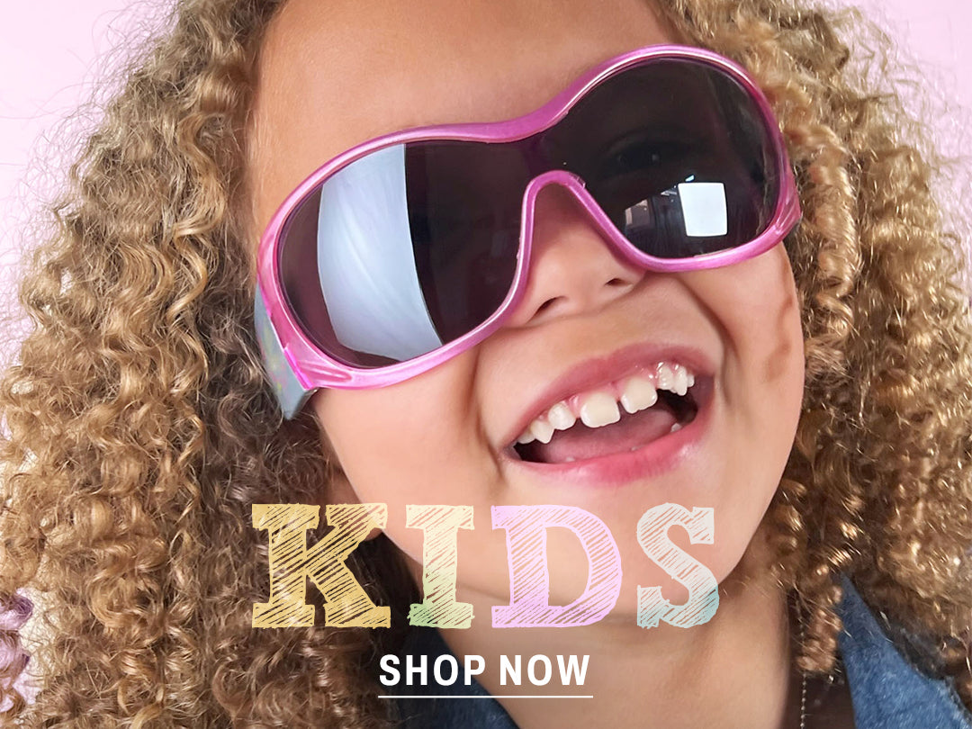 kid in oversized shield sunglasses pink
