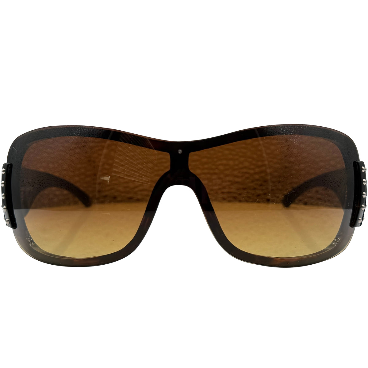 A pair of HANNAH oversized shield-style sunglasses with a glossy black frame and warm brown gradient lenses, shown against a plain white background.