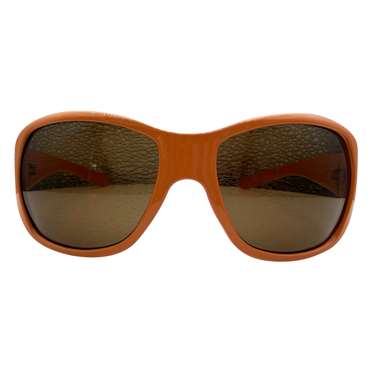 A pair of GLITZ AND GLAM sunglasses with a thick, warm orange-brown frame and dark brown tinted lenses, shown against a plain white background.