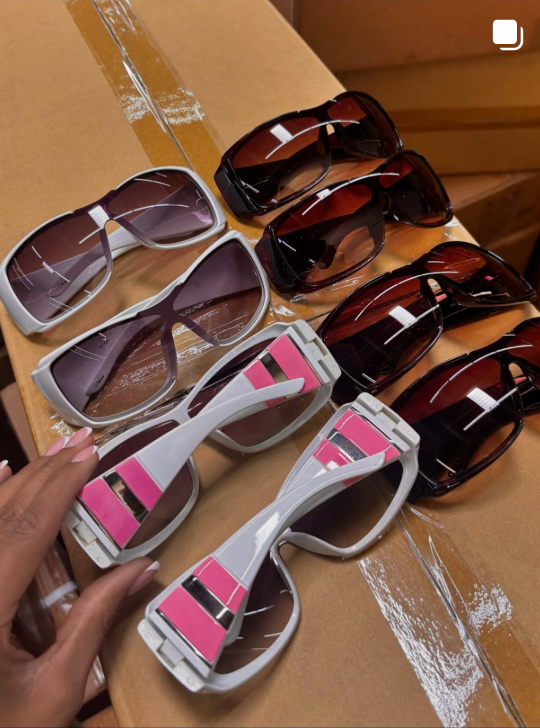 Instagram post showing Sunglasses with pink and white frames on a cardboard surface