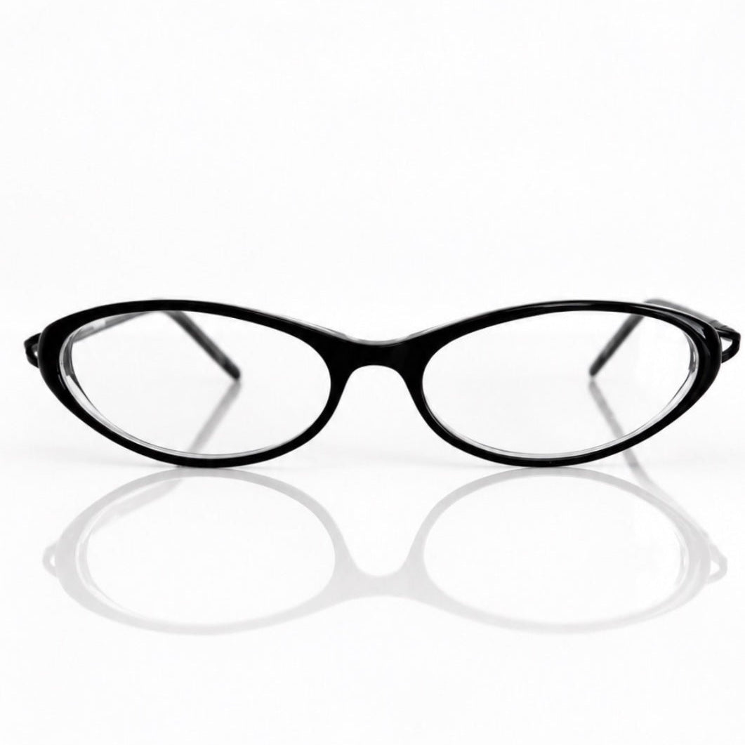Black BANDAGE eyeglasses with clear lenses, displayed on a reflective white surface against a white background.
