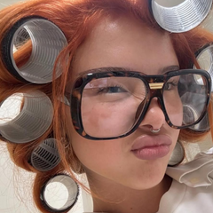 Woman wearing oversized chunky clear glasses with a tortoise frame by Giant Vintage. style: Hipster