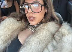 model in a car wearing style called Calculator, an oversized clear aviator glasses