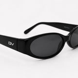 Black oval sunglasses with dark lenses and a visible GV logo on the temple, photographed on a clean white background.