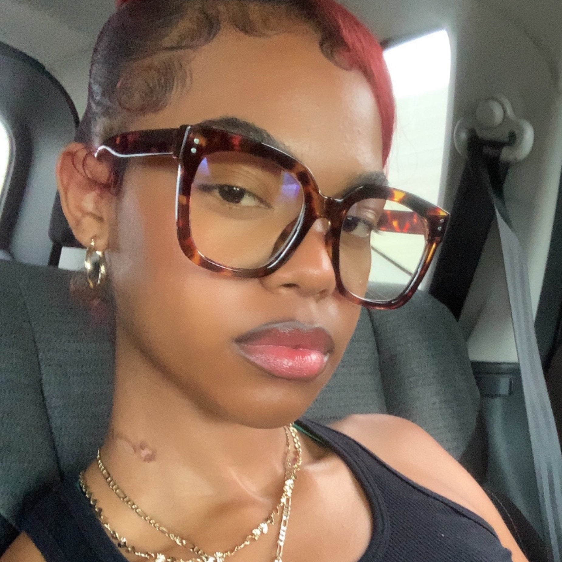 chunky clear round sunglasses with a tortoise-colored frame styled on model