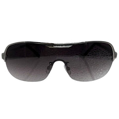 A front-facing product shot of the EXOTIC sunglasses, featuring a rimless shield design with oversized, dark-to-light gradient lenses. The frames are accented by a sleek silver double-bridge bar across the top and silver arms visible through the lenses.