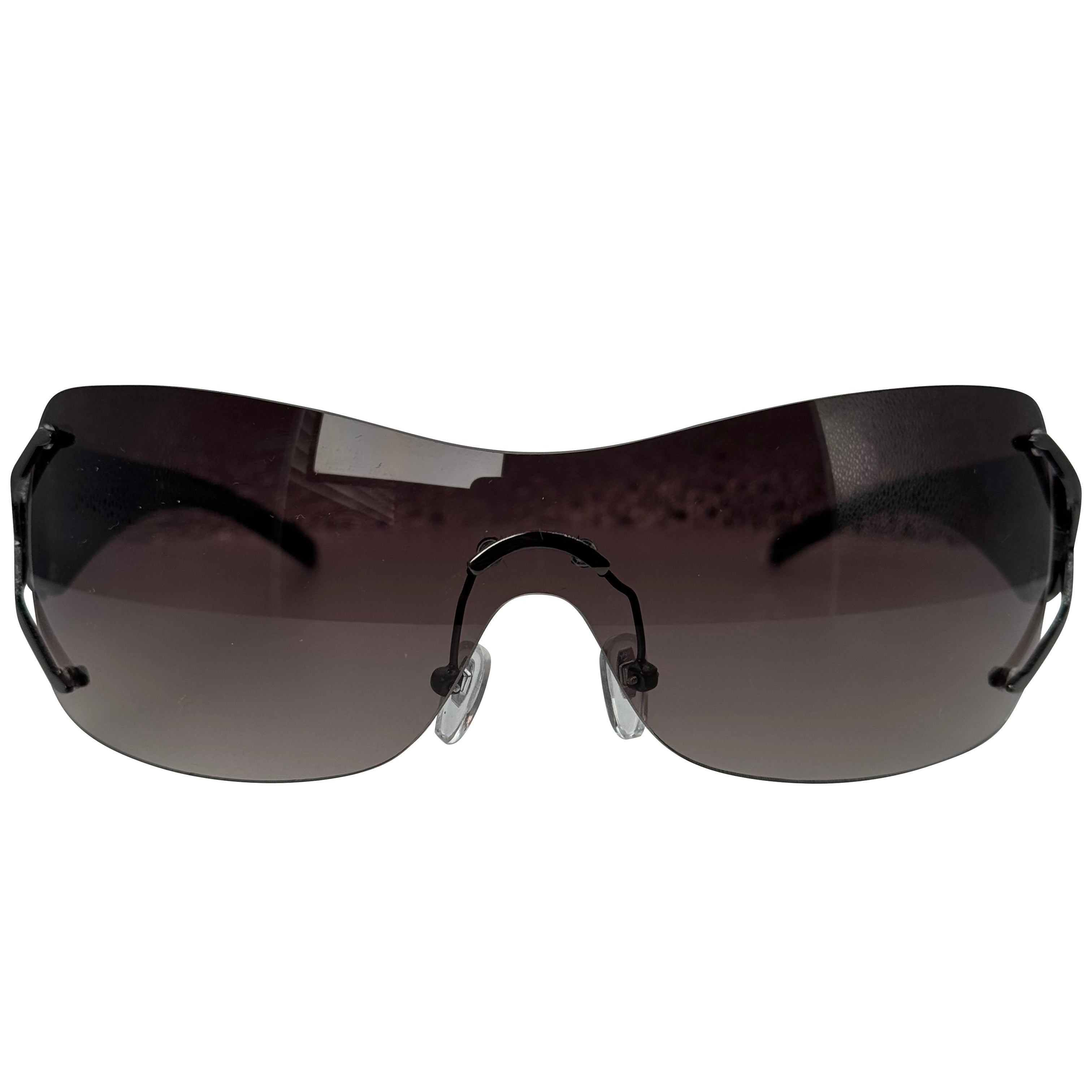 Rimless shield-style sunglasses with a dark brown tinted lens and black frame, shown against a plain white background.