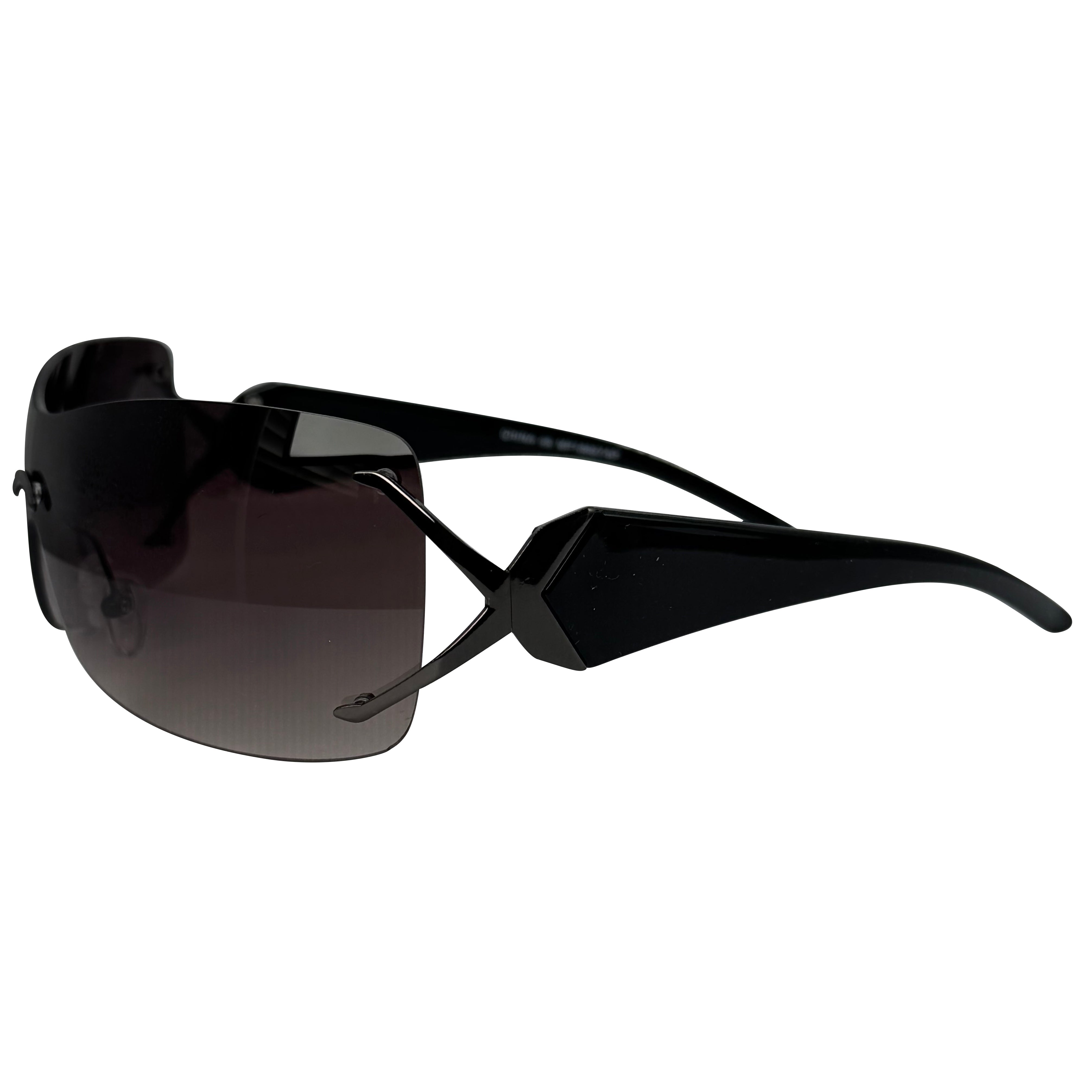 Black wrap-around sunglasses with a gradient dark lens, shown from a side angle on a plain white background.
