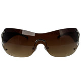 Rimless wraparound sunglasses with dark brown gradient lenses and a black metal frame, shown against a plain white background.