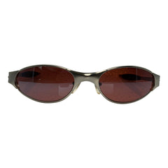 F1 Oval sunglasses with a metallic bronze frame and dark brown lenses, shown against a plain white background.