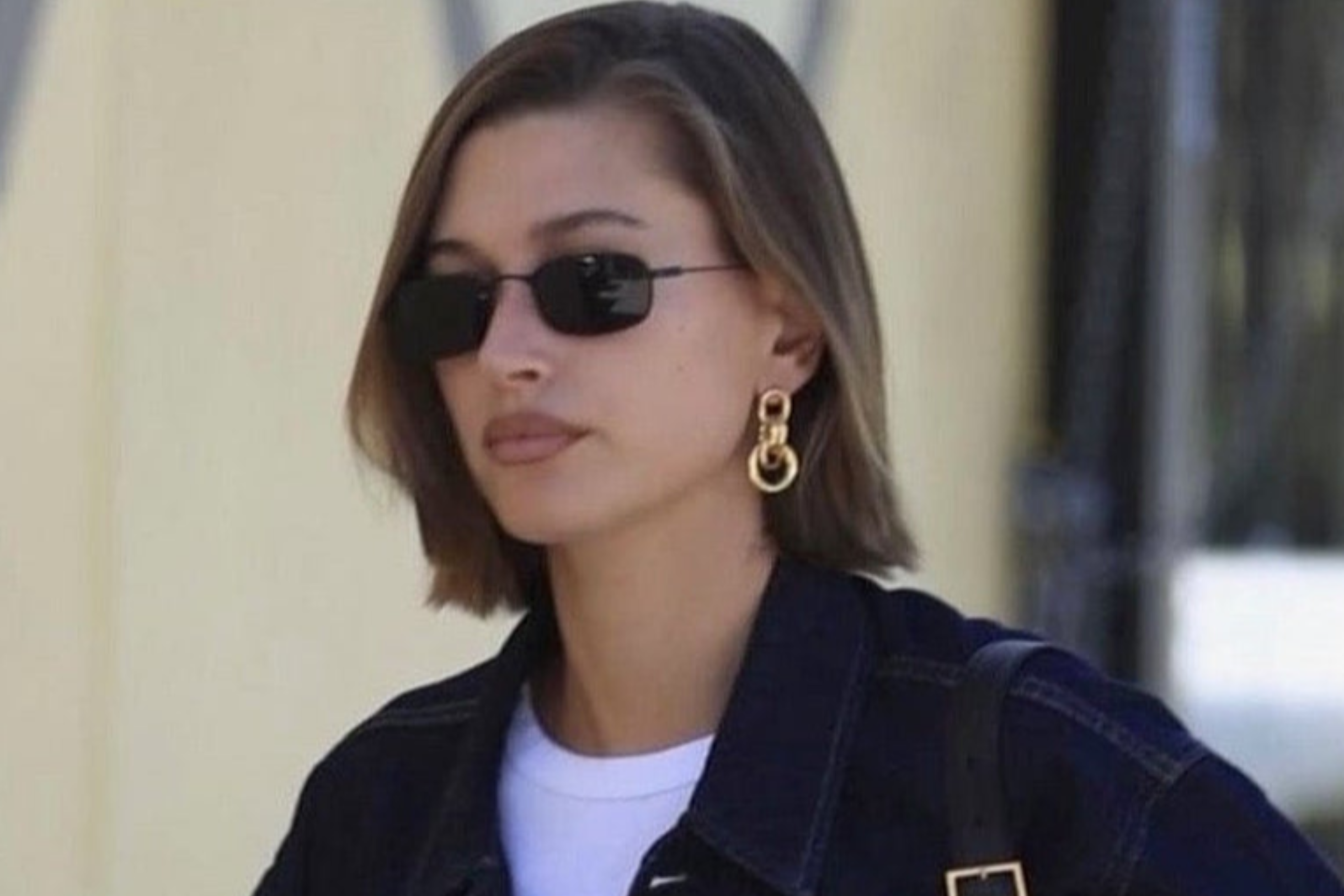Hailey Bieber modeling NORBERT, a style within this trending 90s sunglasses collection