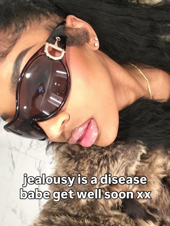 Person wearing sunglasses with text 'jealousy is a disease babe get well soon xx' on a fur surface.