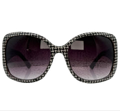 A pair of LANTERN square sunglasses with a black and white houndstooth patterned frame and dark gradient lenses, shown against a plain white background.