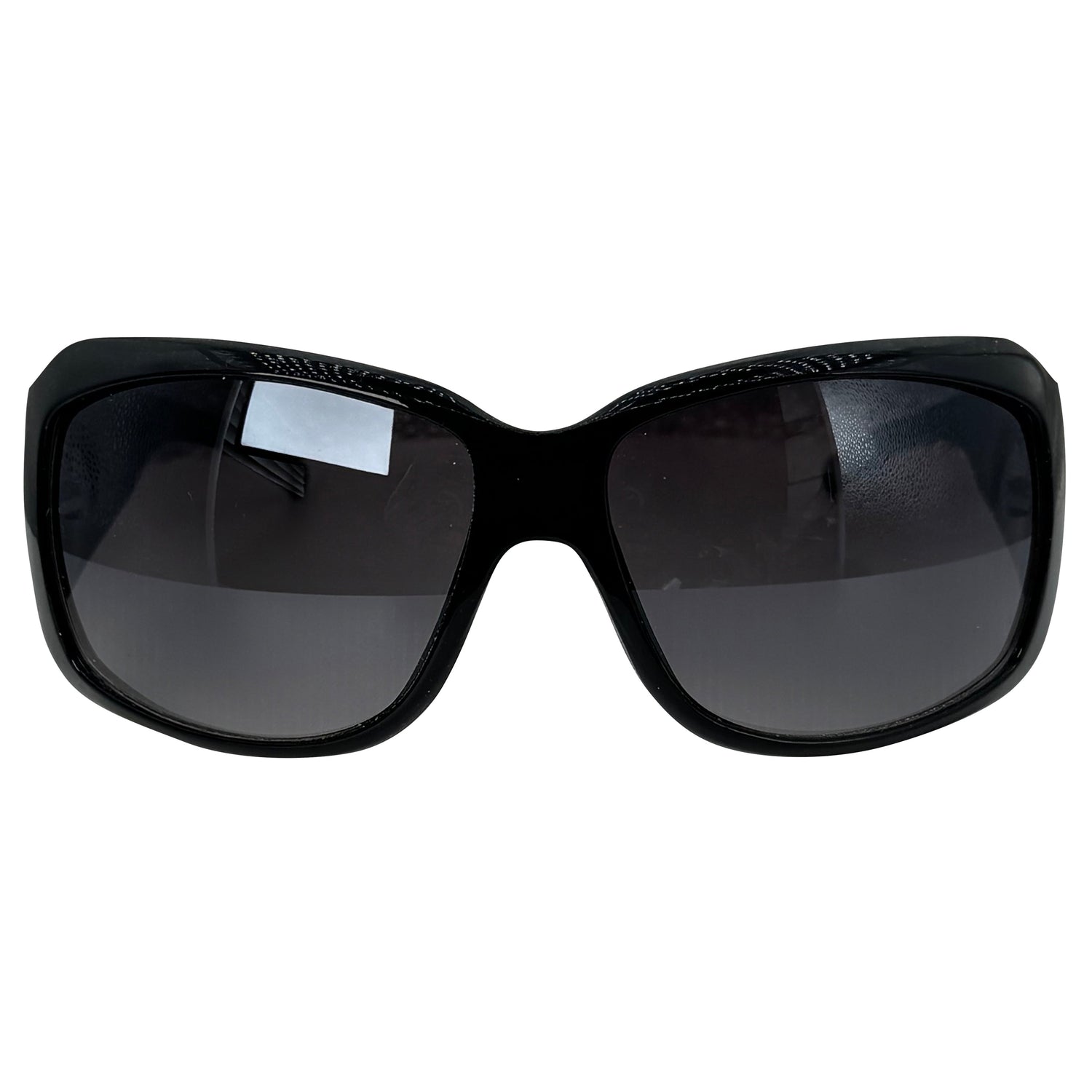 Black oversized sunglasses with dark tinted lenses and a glossy frame, shown against a plain white background.