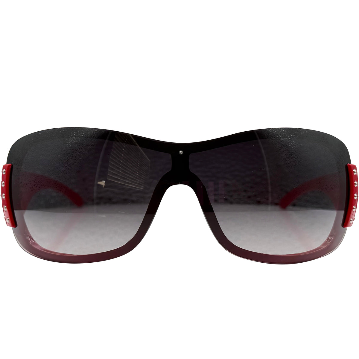 A pair of HANNAH oversized shield sunglasses with a glossy black frame, gradient gray lenses, and red temple tips, shown against a plain white background.