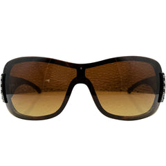 A pair of HANNAH oversized shield-style sunglasses with a glossy black frame and warm brown gradient lenses, shown against a plain white background.