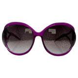 Oversized sunglasses with a translucent purple frame and dark gray gradient lenses, shown against a plain white background.
