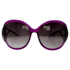 Oversized sunglasses with a translucent purple frame and dark gray gradient lenses, shown against a plain white background.