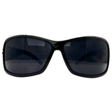 Front view of MYSTERY Shield Sunglasses in a glossy black finish, featuring a bold wrap-around frame and solid "Super Dark" charcoal lenses.