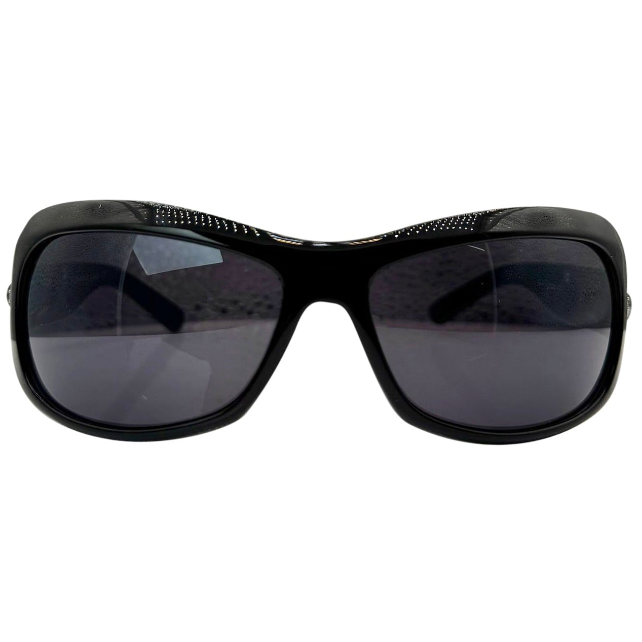 Front view of NICOLE Shield Sunglasses in glossy black featuring a subtle textured pattern along the top brow and solid dark lenses.