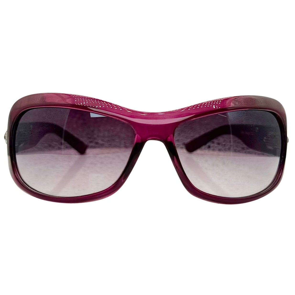 Front view of NICOLE Shield Sunglasses in a vibrant purple frame with dark gradient lenses and decorative detailing on the brow.
