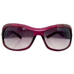 Front view of NICOLE Shield Sunglasses in a vibrant purple frame with dark gradient lenses and decorative detailing on the brow.