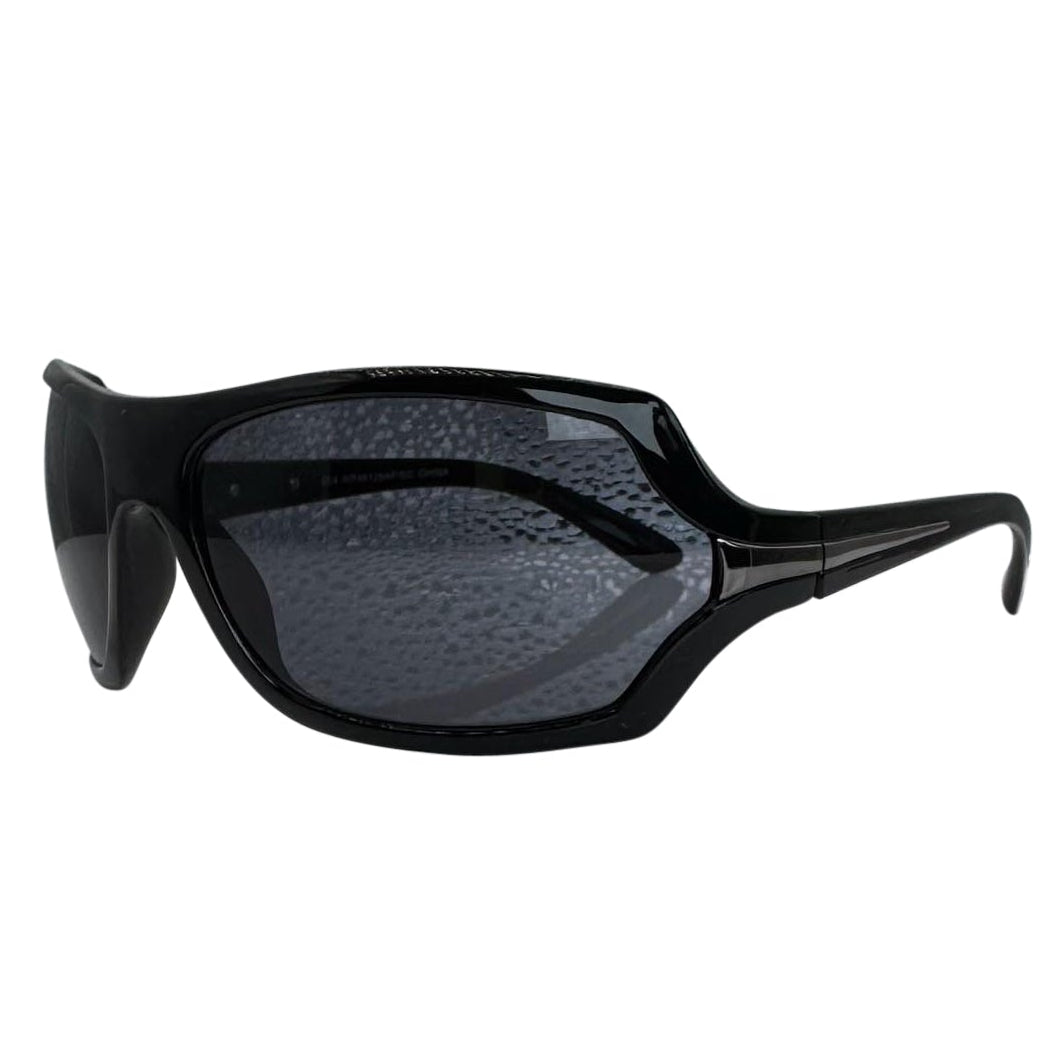 Modern side view of Black EXOTIC Shield sunglasses with a bold, polished black frame and dark gradient lenses, showcasing an edgy aesthetic.