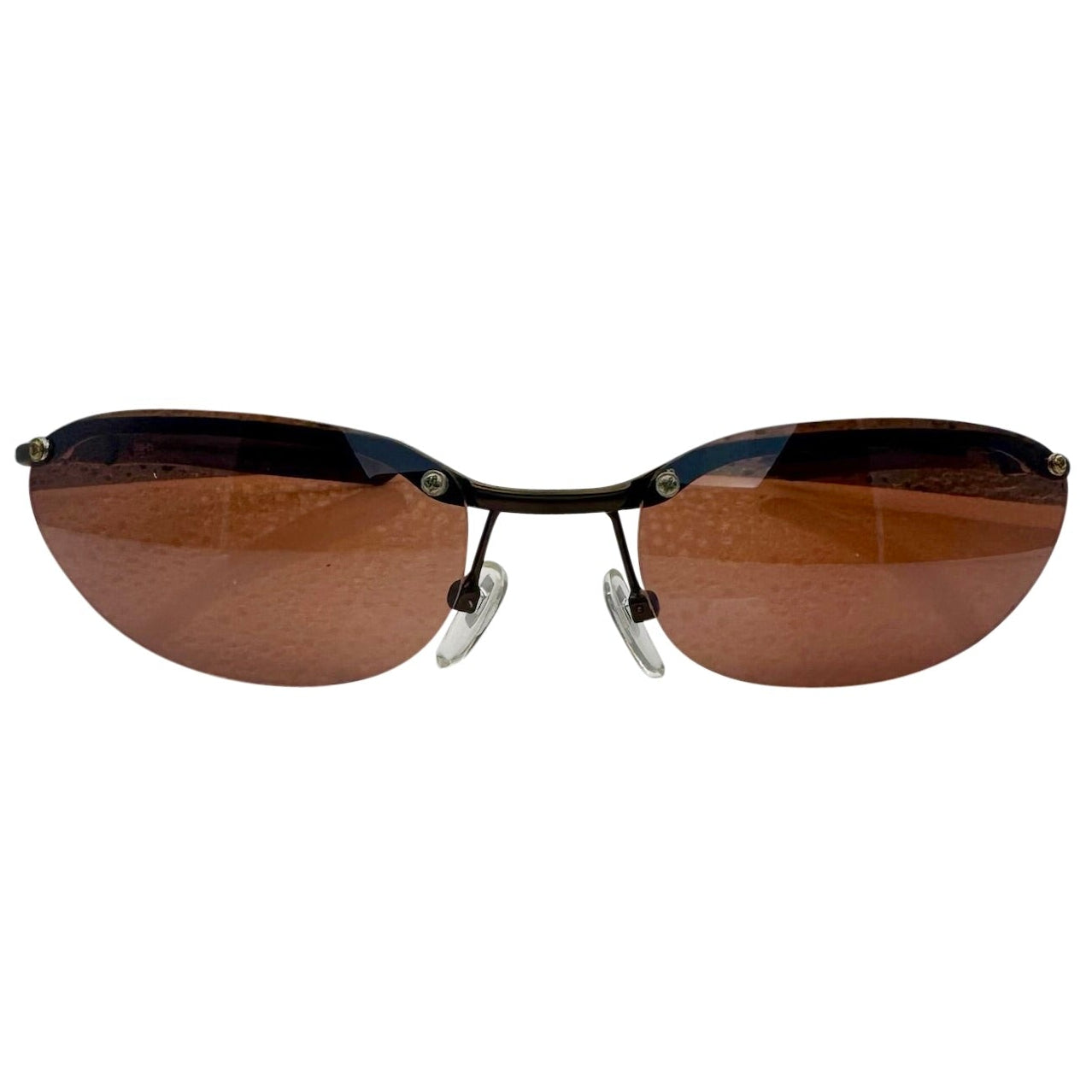Front-facing view of PERFECT 90s Sunglasses featuring a semi-rimless gunmetal bridge and sleek amber-tinted lenses.