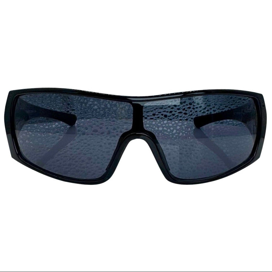Modern front view of the Black RUNNER shield sunglasses with a sleek matte gunmetal grey frame, showcasing a sharp, industrial silhouette and wide wrap-around shield lenses.