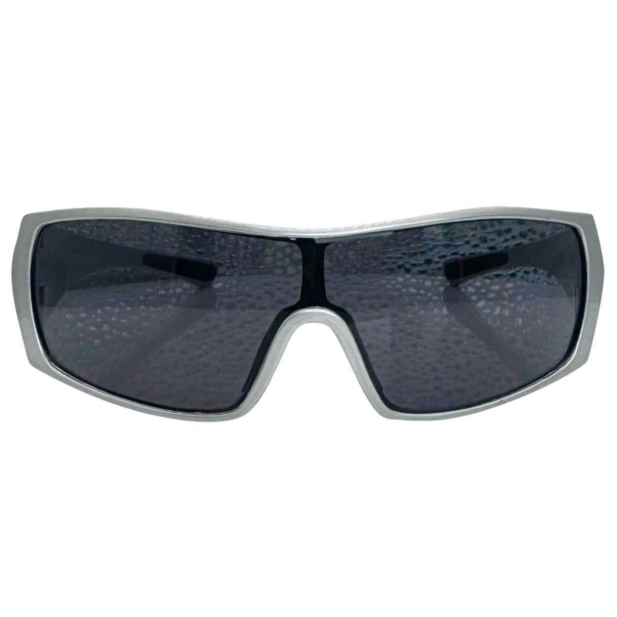 Modern front view of the Grey RUNNER shield sunglasses with a sleek matte gunmetal grey frame, showcasing a sharp, industrial silhouette and wide wrap-around shield lenses.