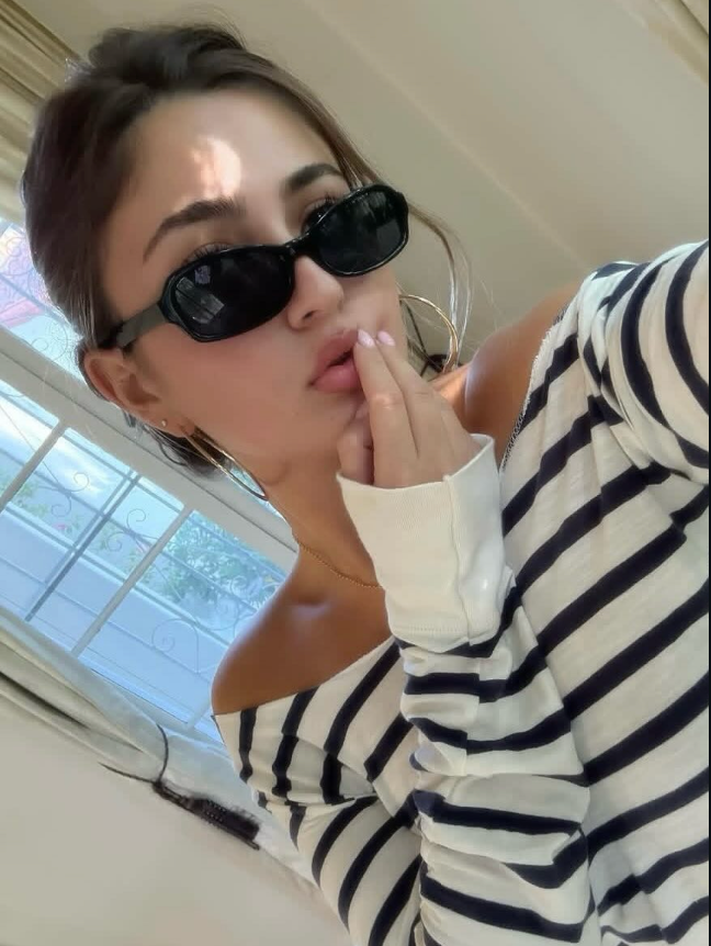 Person wearing black and white striped shirt indoors