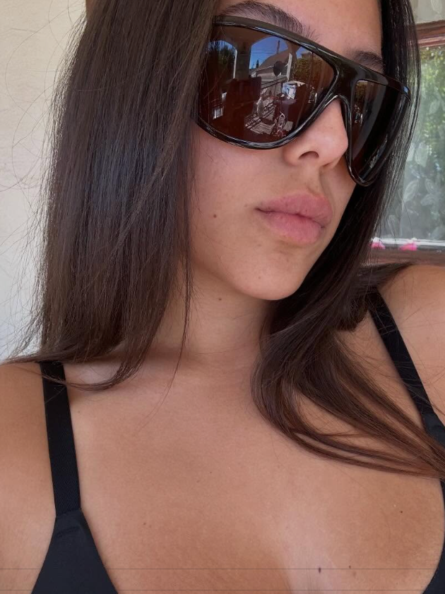 Woman wearing sunglasses with a neutral background