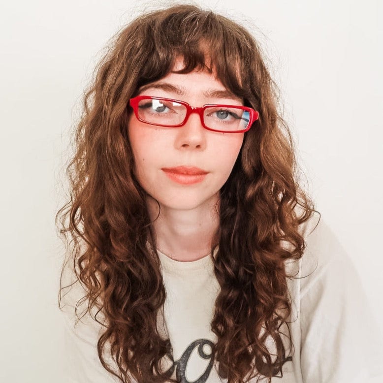 Model wearing ROJO Clear rectangular glasses with red frame