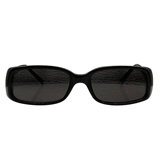 Frontal view of solid black, chunky rectangular sunglasses featuring dark-tinted lenses. The thick acetate frame has a smooth, polished finish with a slightly curved bridge, capturing a bold 90s-inspired minimalist aesthetic.