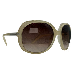 Oversized sunglasses with a textured beige frame and gradient brown lenses, shown from a three-quarters angle on a white background.