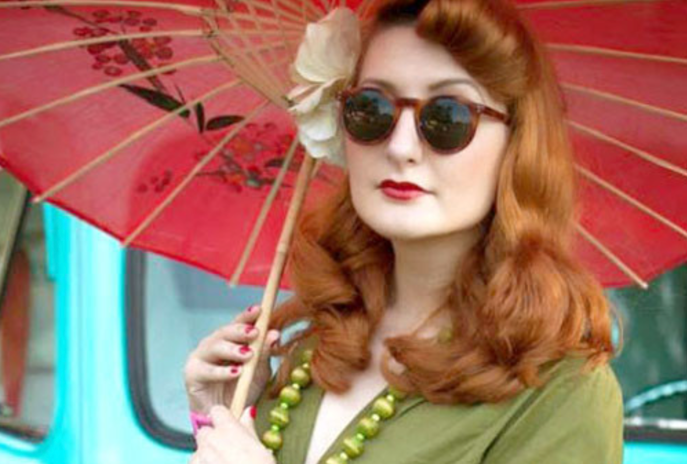 woman with umbrella and dark sunglasses