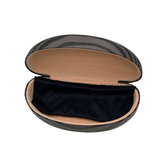 An angled perspective of the open black ZEBRA case, highlighting the protective hard-shell structure and the contrast between the grey zebra-print exterior and the soft tan interior.