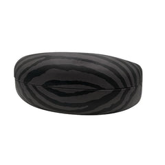 A side profile of the closed black sunglasses case, emphasizing its "chunky" protective silhouette and the seamless wrap-around zebra print.