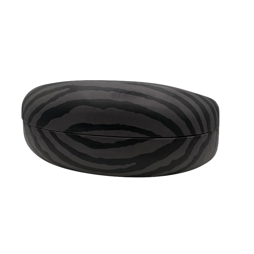 A side profile of the closed black sunglasses case, emphasizing its 