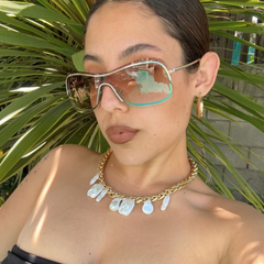 model wearing a giant vintage original sunglass style called REDS amber